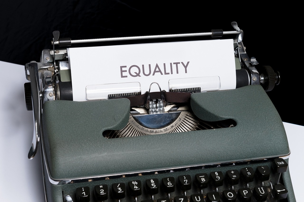 Fair Housing typewriter with the work equality on a sheet of paper.